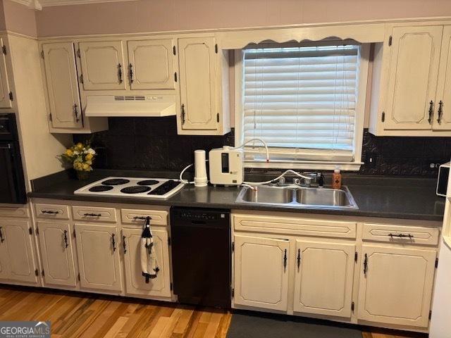 kitchen featuring white cabinetry, sink, and black appliances