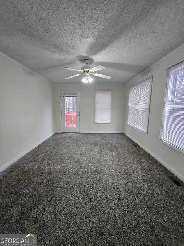 empty room with a textured ceiling, ceiling fan, and carpet