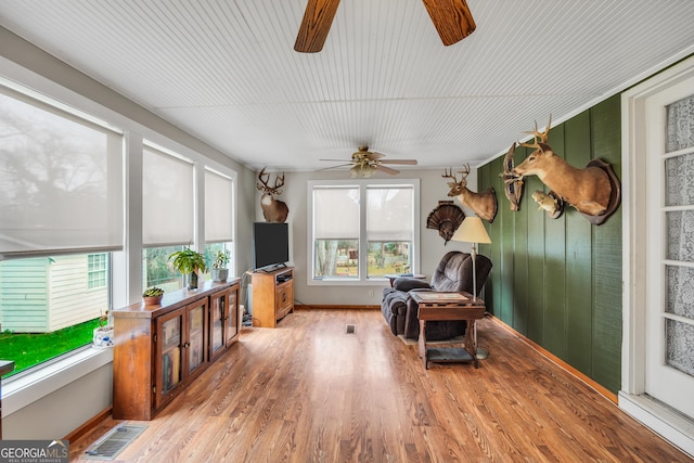 sunroom featuring ceiling fan