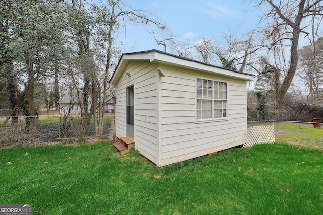 view of outbuilding with a yard