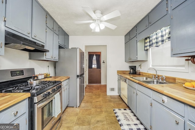 kitchen with wood counters, sink, and appliances with stainless steel finishes