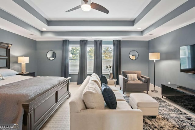 bedroom featuring a tray ceiling and ceiling fan