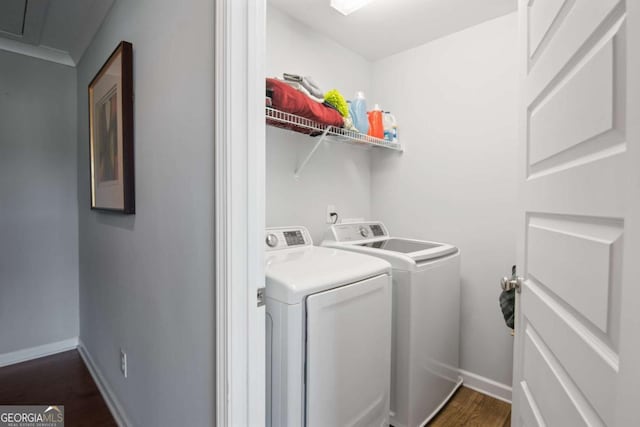 clothes washing area featuring dark hardwood / wood-style flooring and washing machine and dryer