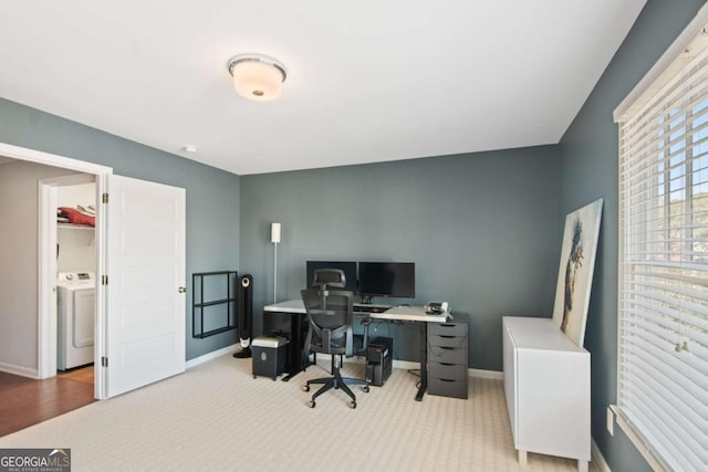 carpeted office space featuring washer / clothes dryer