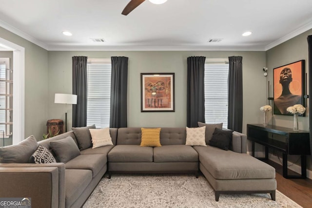 living room featuring light hardwood / wood-style flooring, ornamental molding, and ceiling fan