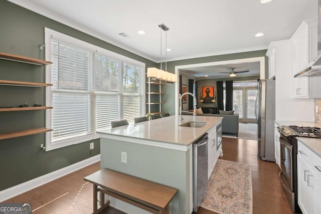 kitchen featuring a kitchen island with sink, sink, white cabinetry, and appliances with stainless steel finishes