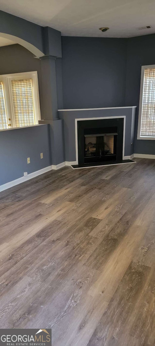 unfurnished living room with hardwood / wood-style flooring