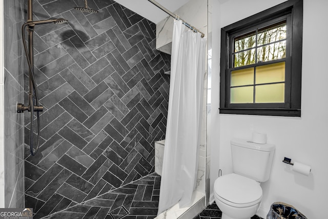 bathroom with curtained shower and toilet