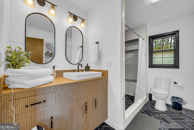 bathroom featuring vanity, toilet, and a shower with shower curtain