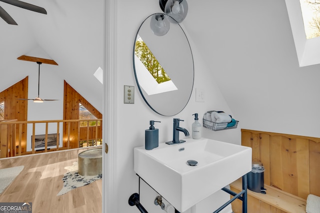 bathroom with hardwood / wood-style flooring, vaulted ceiling, sink, and ceiling fan