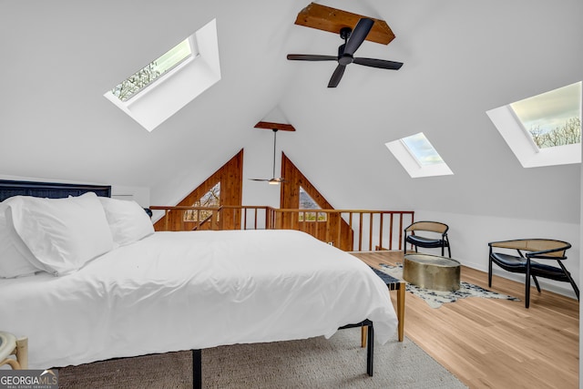 bedroom with lofted ceiling and wood-type flooring