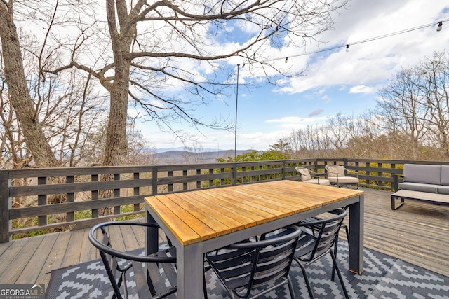 wooden deck with a mountain view