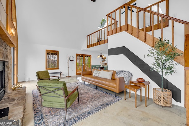 living room featuring a towering ceiling and french doors