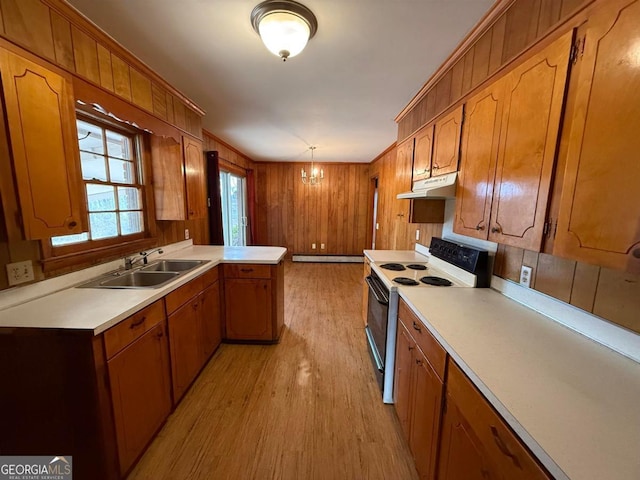 kitchen featuring decorative light fixtures, sink, a chandelier, light hardwood / wood-style floors, and electric stove