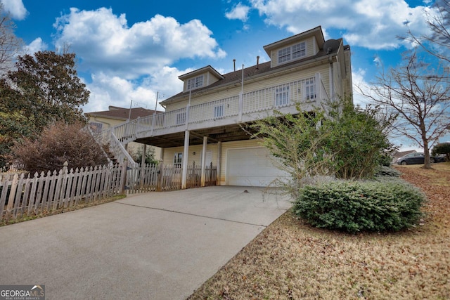 view of front of house featuring a garage and a deck