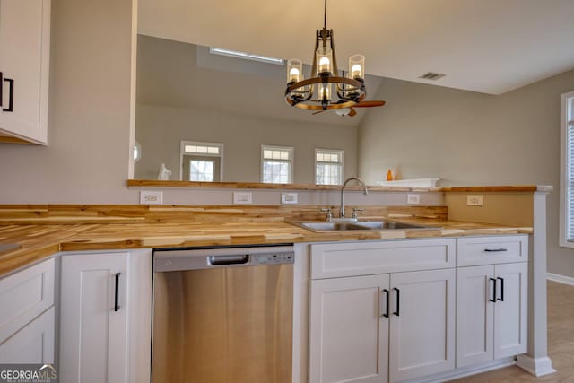 kitchen with white cabinetry, hanging light fixtures, sink, and dishwasher