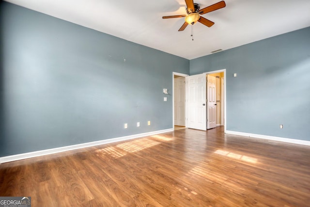 spare room with ceiling fan and wood-type flooring