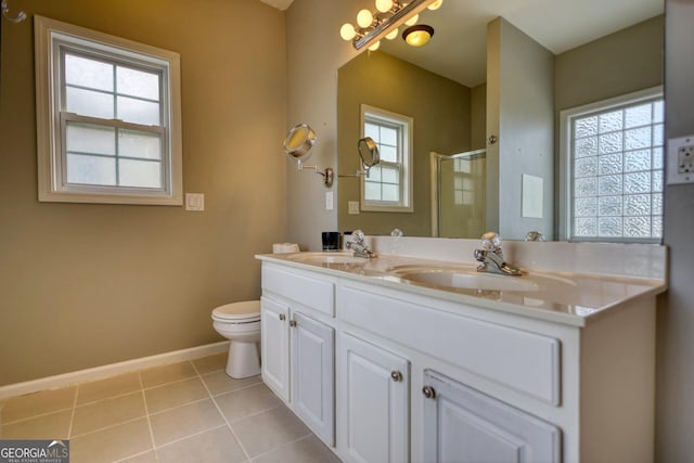 bathroom with toilet, vanity, tile patterned floors, and walk in shower