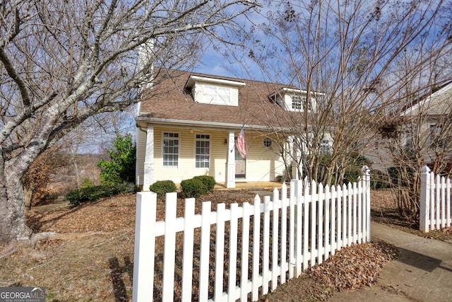 cape cod-style house featuring covered porch