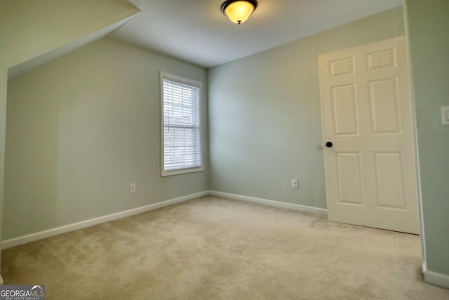 additional living space with lofted ceiling and light colored carpet