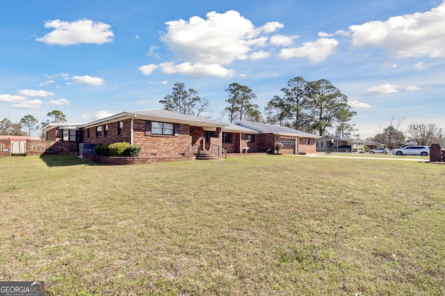 ranch-style house featuring a garage and a front lawn