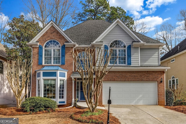 traditional-style house featuring driveway, a shingled roof, a garage, and brick siding