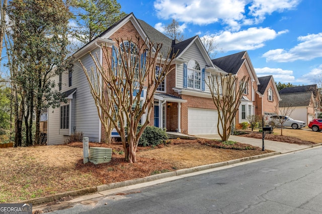 traditional-style home featuring brick siding, driveway, and an attached garage