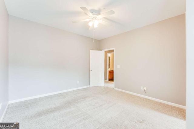 unfurnished room with ceiling fan and light colored carpet