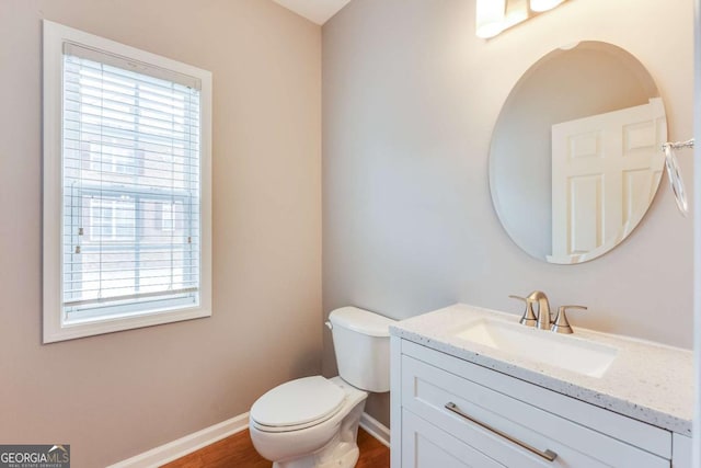 bathroom featuring vanity, toilet, and wood-type flooring