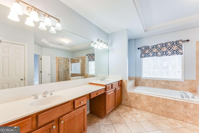 bathroom featuring vanity, separate shower and tub, tile patterned floors, and a tray ceiling