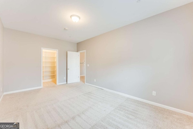 spare room featuring light colored carpet