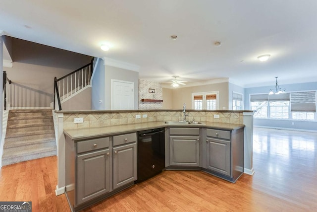 kitchen with sink, gray cabinets, dishwasher, decorative backsplash, and decorative light fixtures