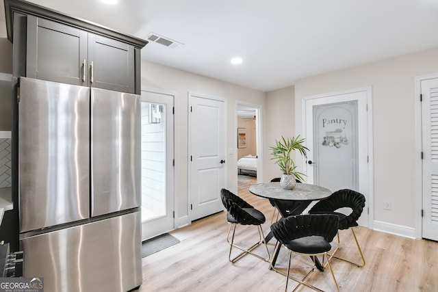 dining space featuring light wood-type flooring