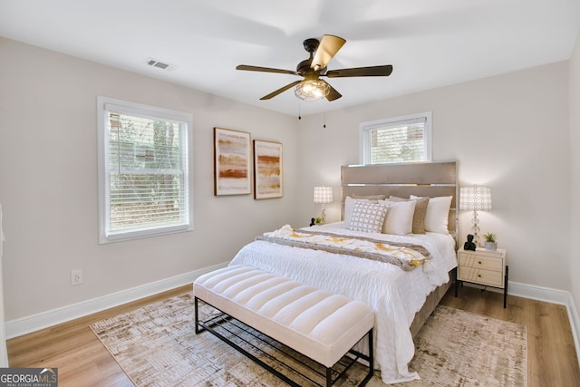 bedroom with hardwood / wood-style floors and ceiling fan