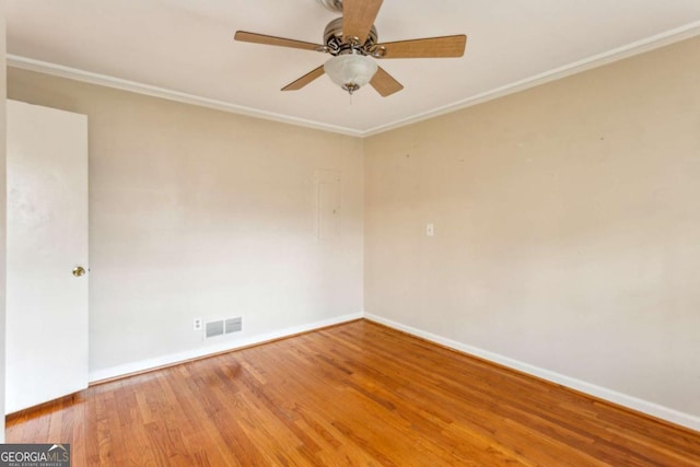 spare room featuring hardwood / wood-style flooring, crown molding, and ceiling fan