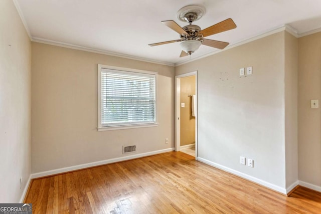 unfurnished room with ornamental molding, ceiling fan, and light wood-type flooring