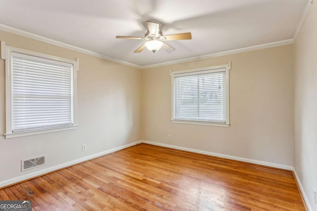 spare room featuring ceiling fan, ornamental molding, and hardwood / wood-style floors