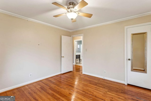 unfurnished room featuring hardwood / wood-style flooring, ornamental molding, and ceiling fan