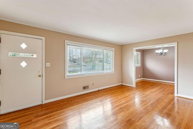 entryway featuring a chandelier and light hardwood / wood-style flooring