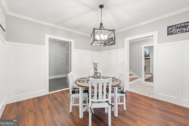 dining room with dark hardwood / wood-style flooring, a notable chandelier, and crown molding