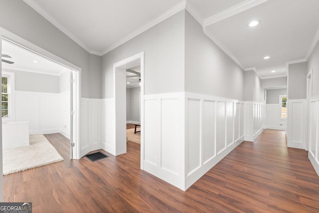 corridor featuring ornamental molding and dark hardwood / wood-style floors