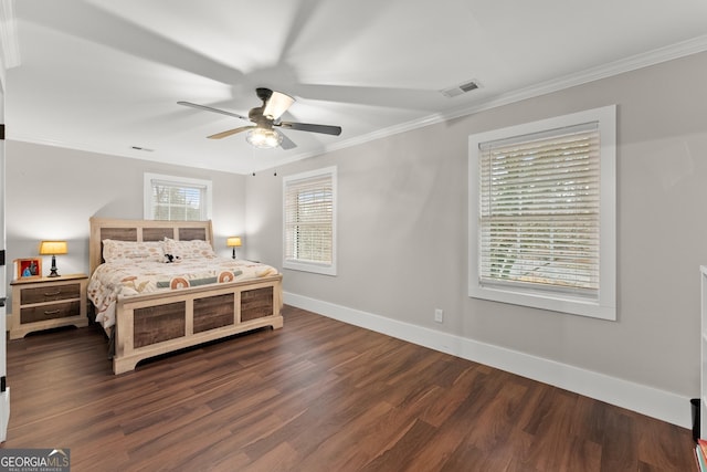 bedroom with crown molding, dark wood-type flooring, and ceiling fan