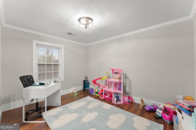 rec room with dark wood-type flooring and ornamental molding