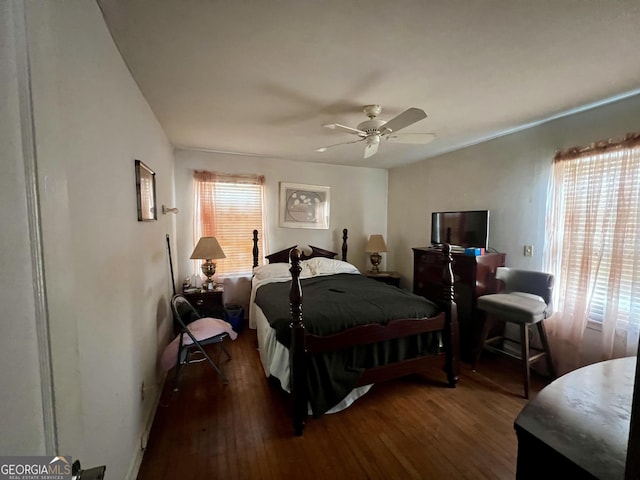 bedroom with ceiling fan and dark hardwood / wood-style flooring