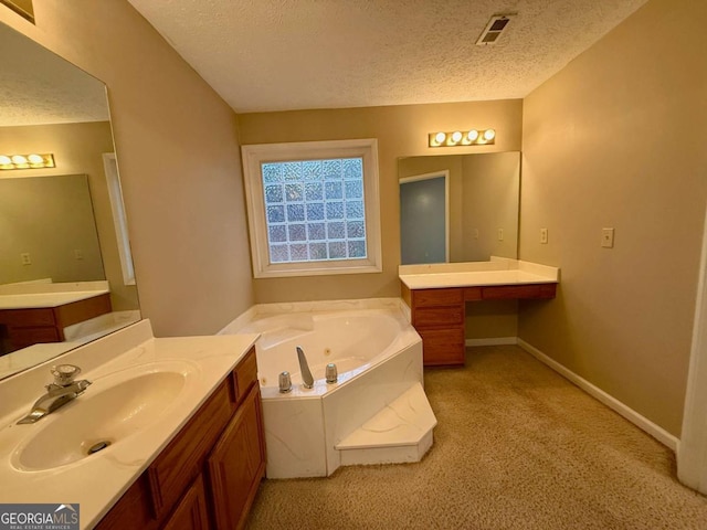 bathroom featuring vanity, a bathtub, and a textured ceiling