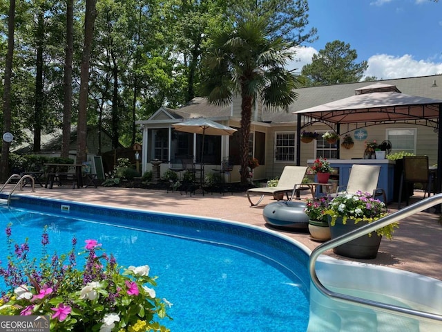 view of swimming pool featuring a gazebo and a patio