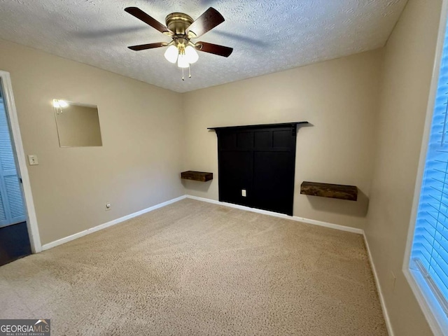 unfurnished bedroom featuring ceiling fan and a textured ceiling