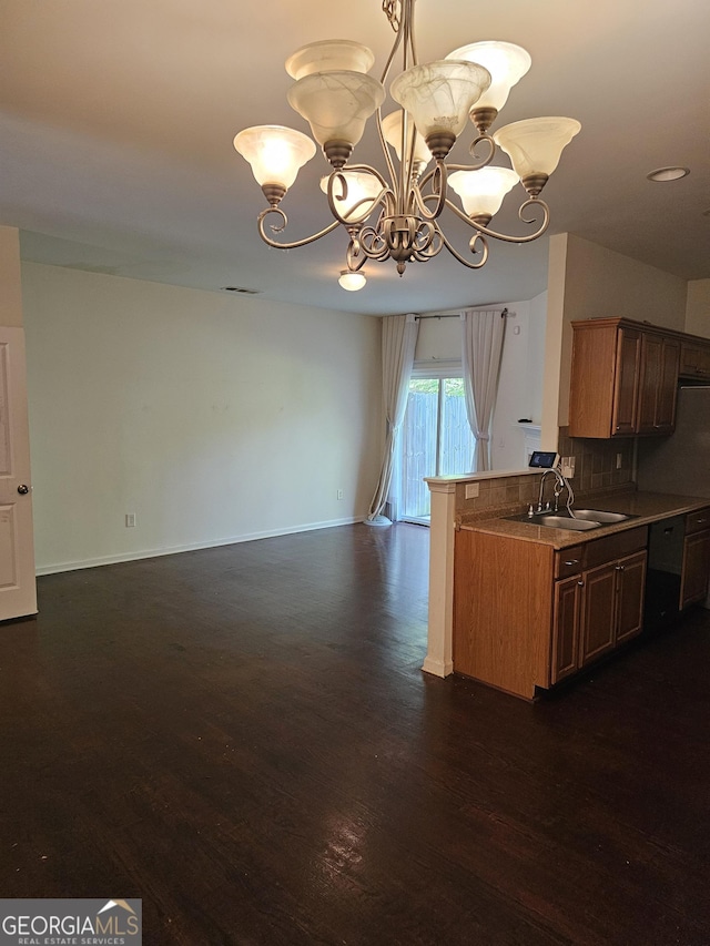 2764 Keystone Ave, Lithonia, GA 30058 - kitchen featuring a sink, a chandelier, dishwashing machine, dark wood-style flooring, and tasteful backsplash
