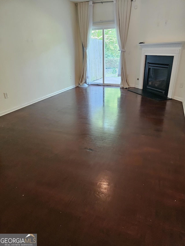 2764 Keystone Ave, Lithonia, GA 30058 - unfurnished living room with baseboards, a fireplace with flush hearth, and dark wood-type flooring