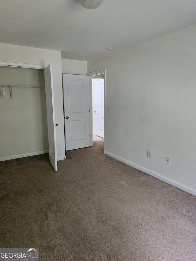 2764 Keystone Ave, Lithonia, GA 30058 - unfurnished bedroom featuring carpet floors, baseboards, and a closet